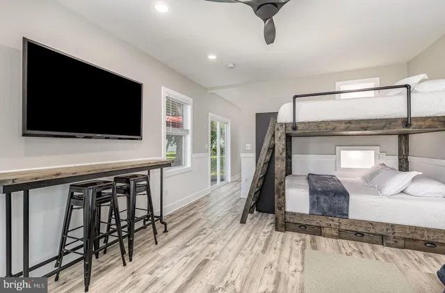 a bedroom with furniture and a flat screen tv