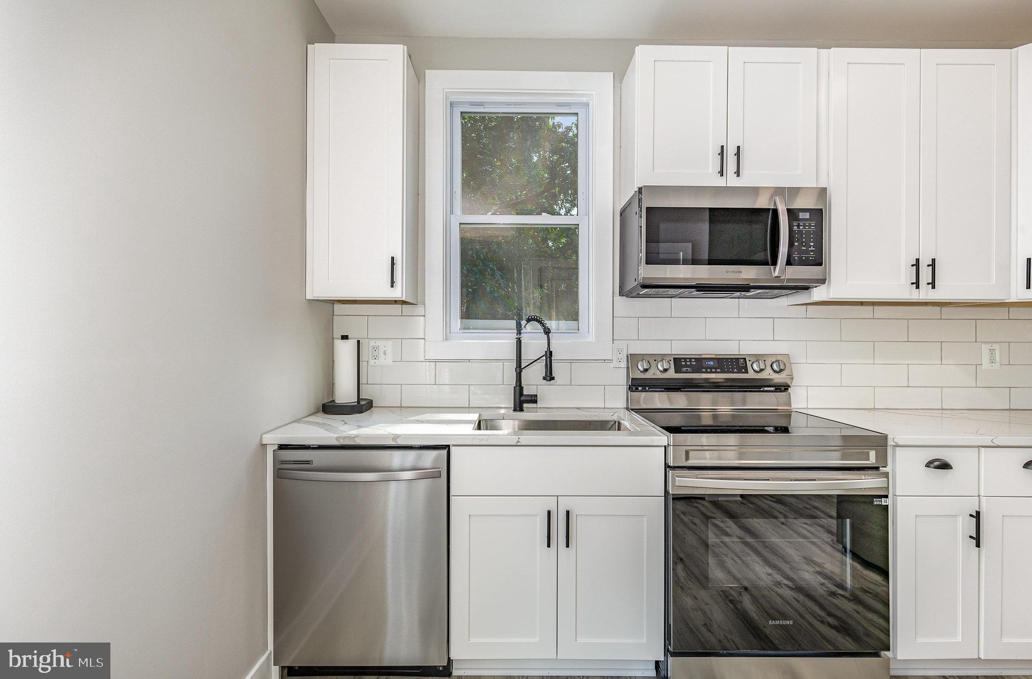 530 Monroe Bay Avenue Colonial Beach, VA 22443 - Photo 7 of 33 a kitchen with cabinets stainless steel appliances and sink