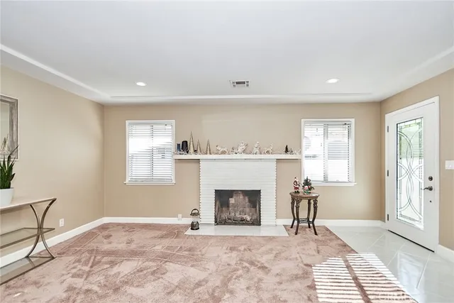 a bedroom with a bed and a large mirror on the dresser