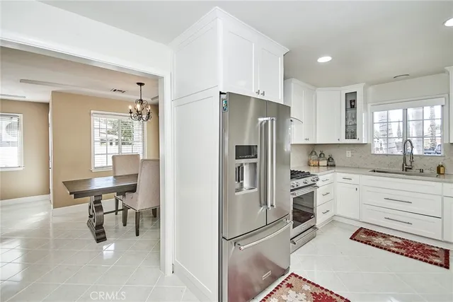 a bathroom with a granite countertop sink toilet and a mirror