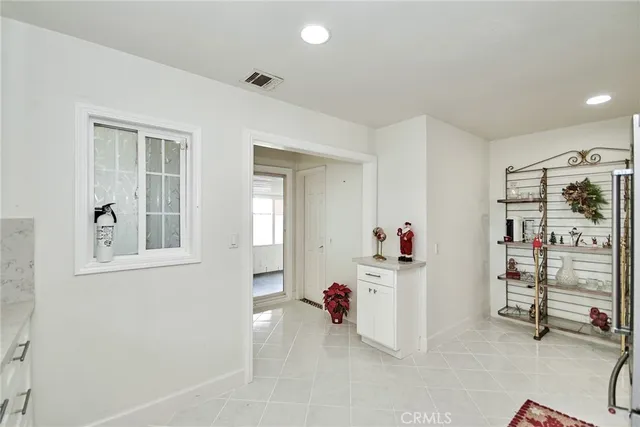 a dining room with furniture and a floor to ceiling window