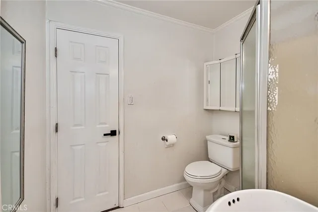 a bedroom with a bed and a view of bathroom