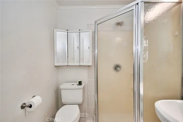 a bedroom with a bed and a desk next to a window