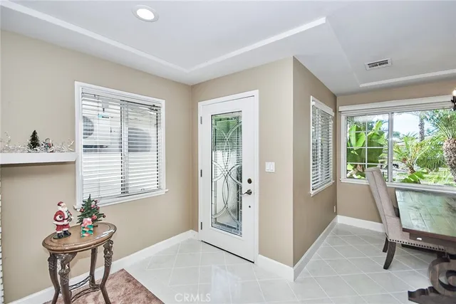 a view of a house with a yard and palm trees