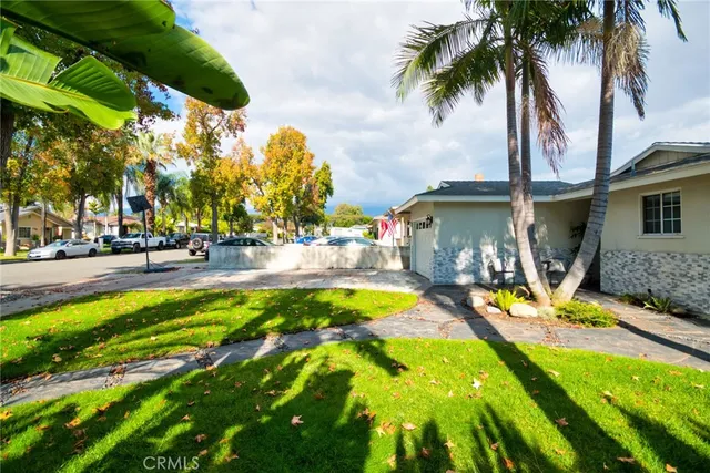 a view of swimming pool with lawn chairs under an umbrella