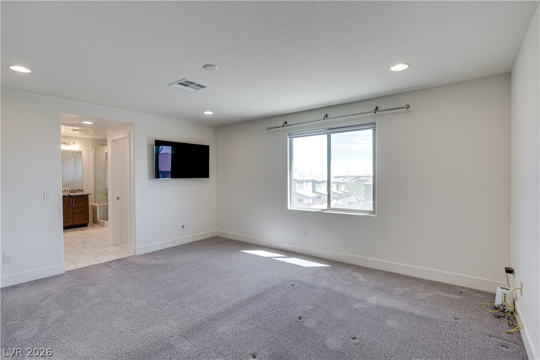 5954 Smith Valley Road Las Vegas, NV 89148 - Photo 13 of 23 A spacious, naturally illuminated room features plush carpeting and a large window offering city views.