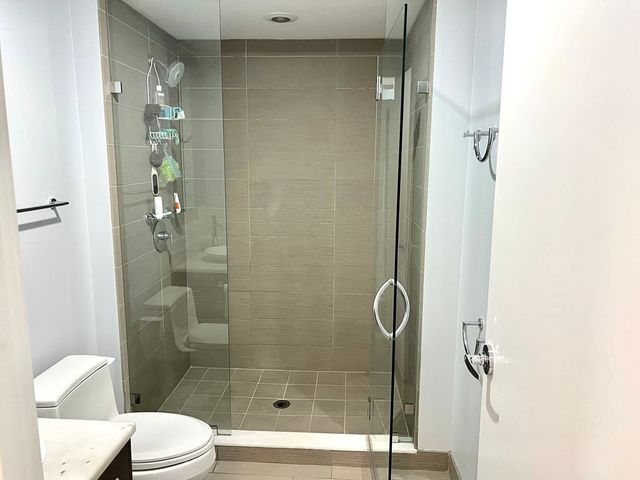 a bathroom with a shower and toilet