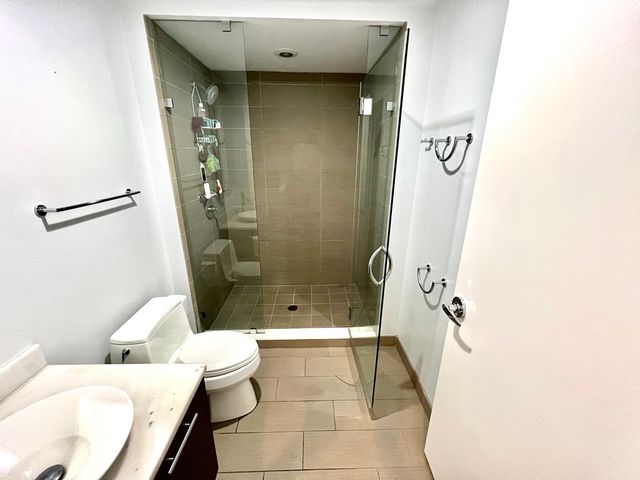 a bathroom with a shower and a toilet