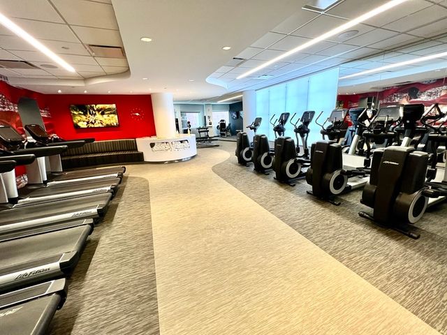 a room with gym equipment and a flat screen tv