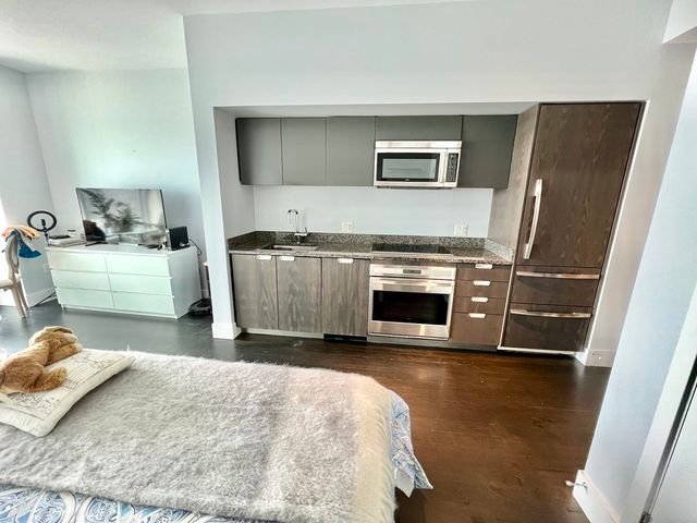 a kitchen with a sink and a stove top oven