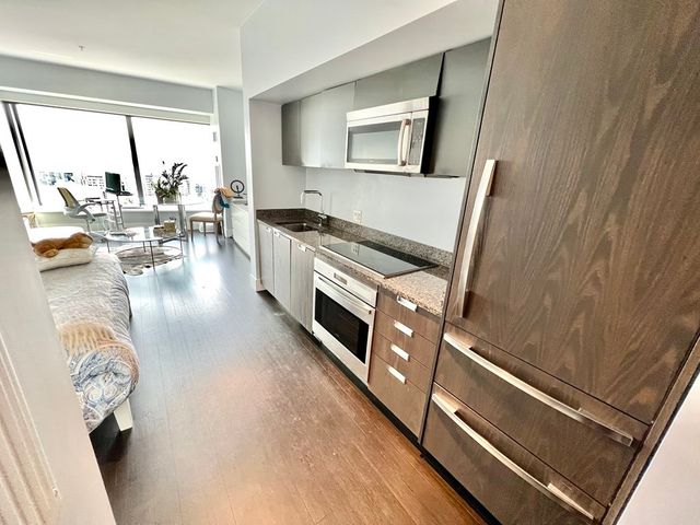 a kitchen with sink refrigerator and window