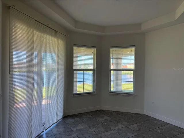 a view of an empty room with glass door