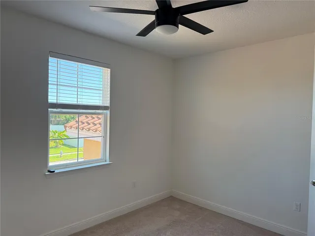 a view of a big room with wooden floor and windows