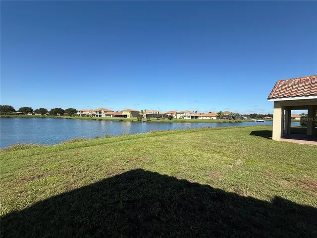 an aerial view of a house with a yard and lake view
