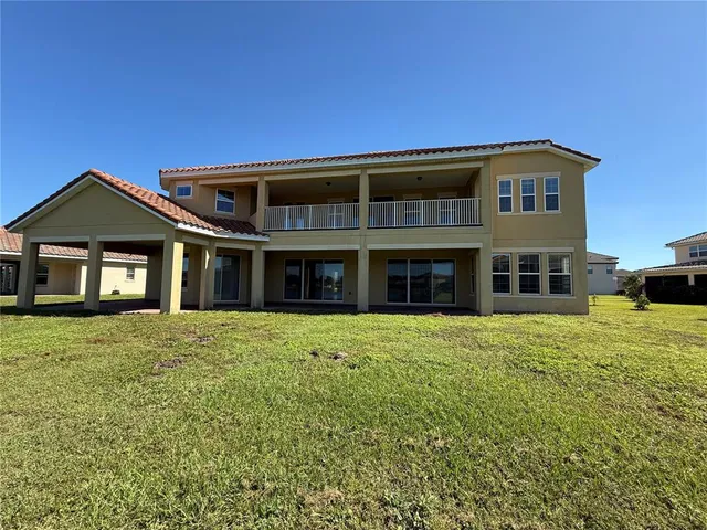 an aerial view of a residential houses with yard