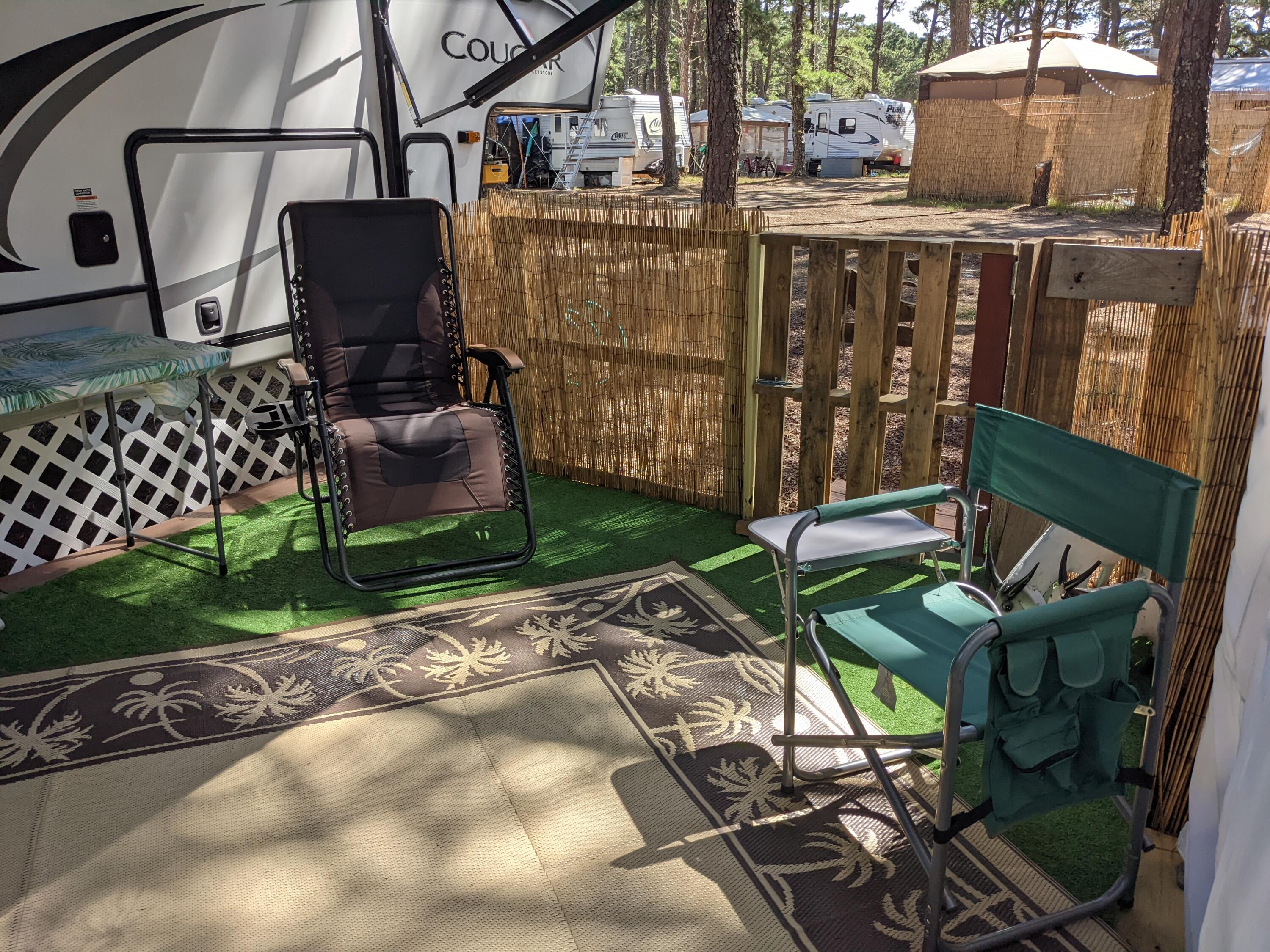 80 Route 6 Wellfleet, MA 02667 - Photo 14 of 23 a backyard of a house with barbeque oven table and chairs