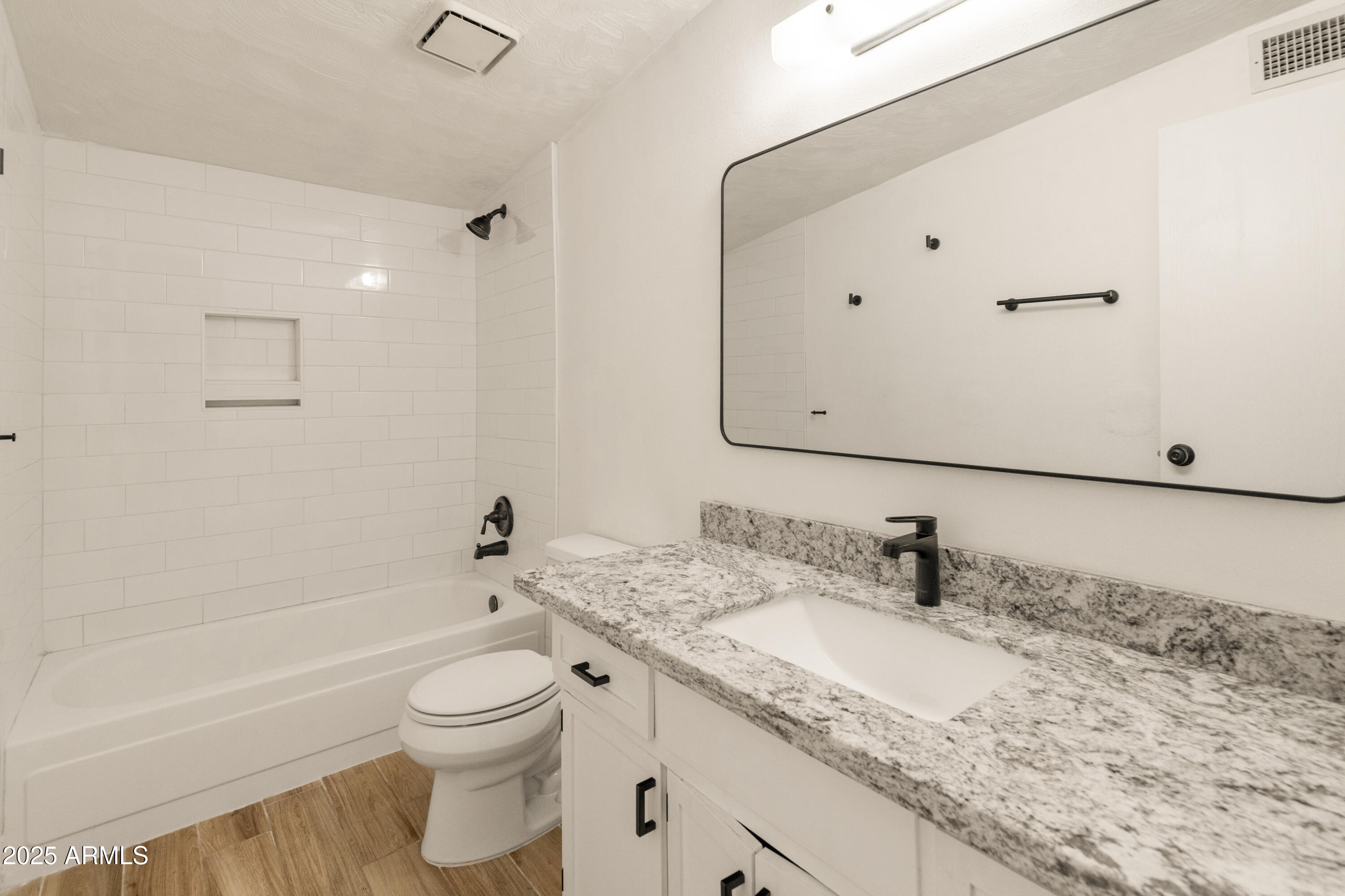 1407 East Mountain View Road Phoenix, AZ 85020 - Photo 12 of 35 a bathroom with a granite countertop sink a toilet and a bathtub