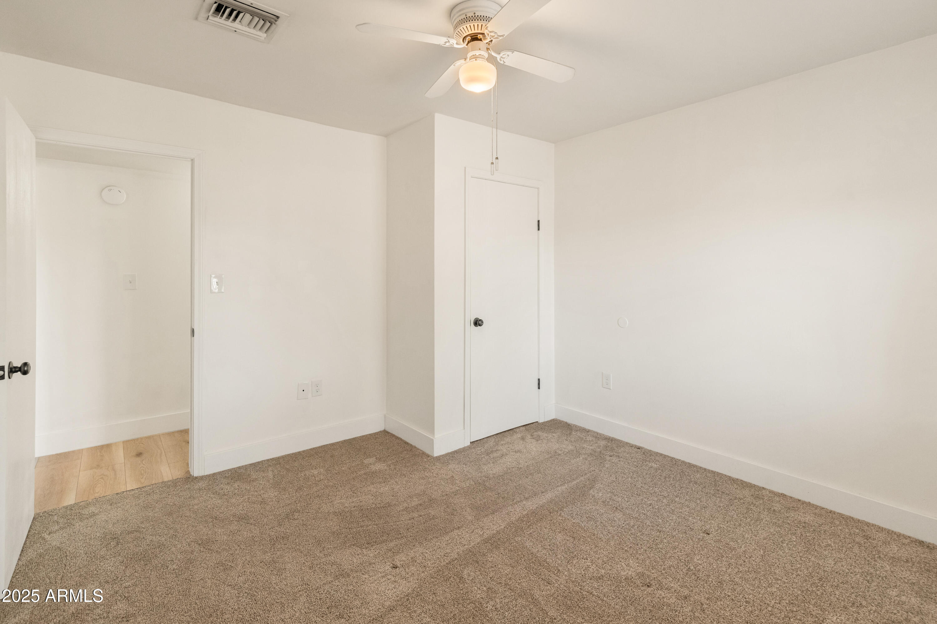 1407 East Mountain View Road Phoenix, AZ 85020 - Photo 14 of 35 an empty room with a ceiling fan and a window