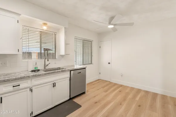 a kitchen with a sink cabinets and window