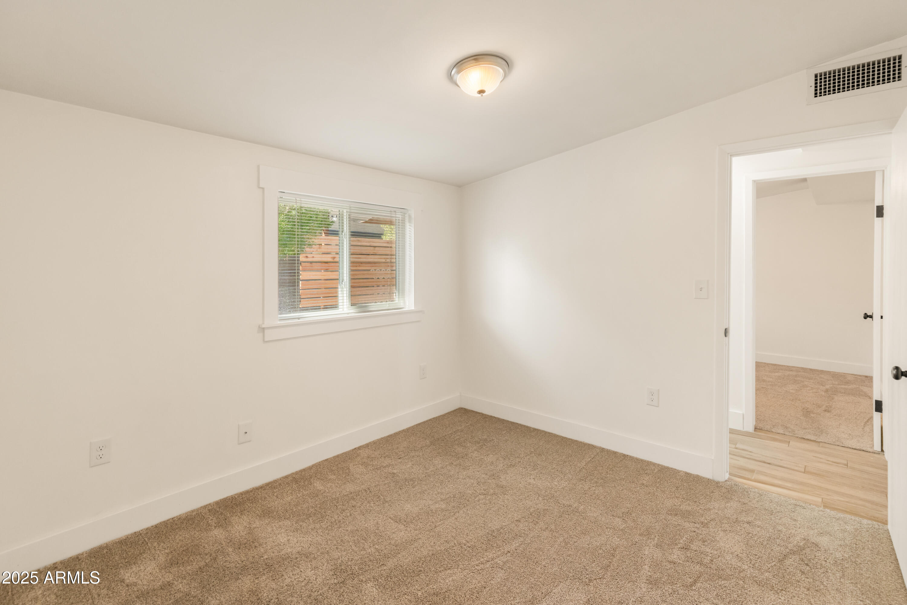 1407 East Mountain View Road Phoenix, AZ 85020 - Photo 21 of 35 an empty room with a window