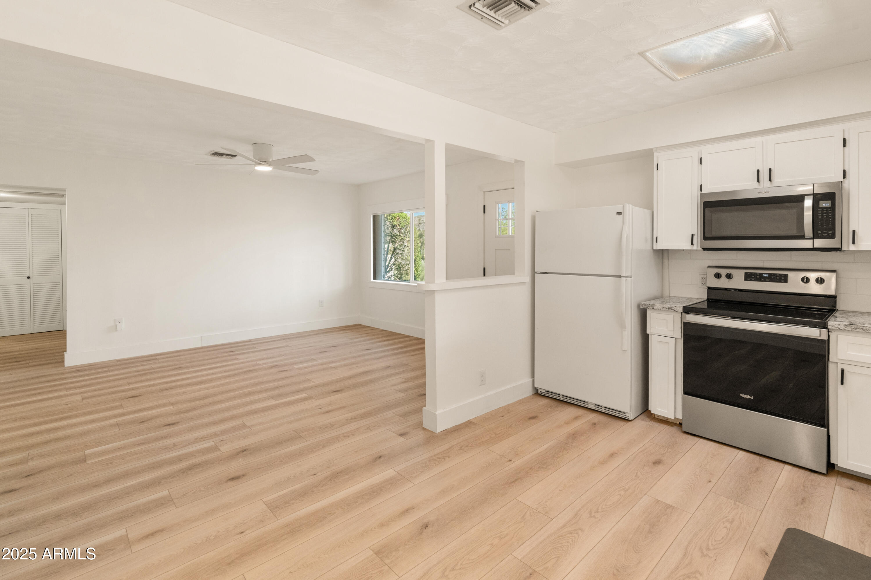 1407 East Mountain View Road Phoenix, AZ 85020 - Photo 4 of 35 a view of a kitchen with wooden floor electronic appliances and windows