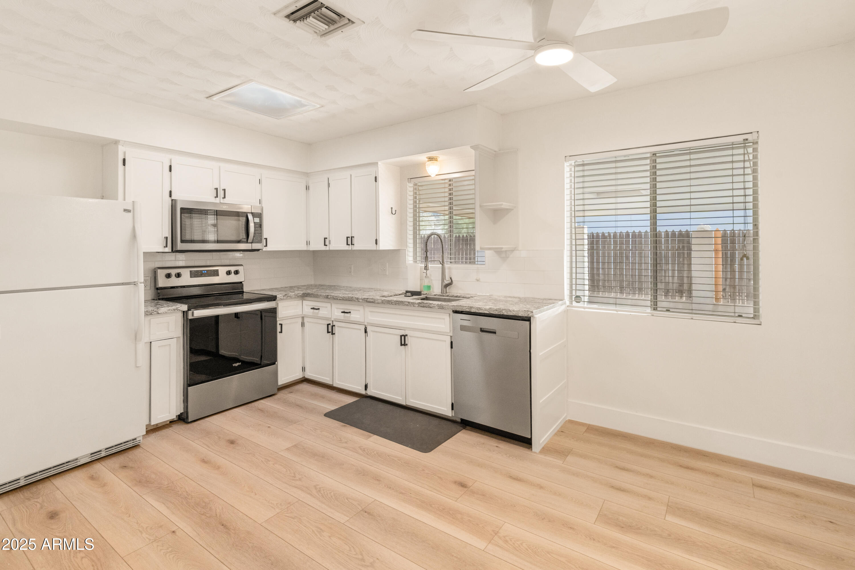 1407 East Mountain View Road Phoenix, AZ 85020 - Photo 5 of 35 a kitchen with cabinets stainless steel appliances and a window