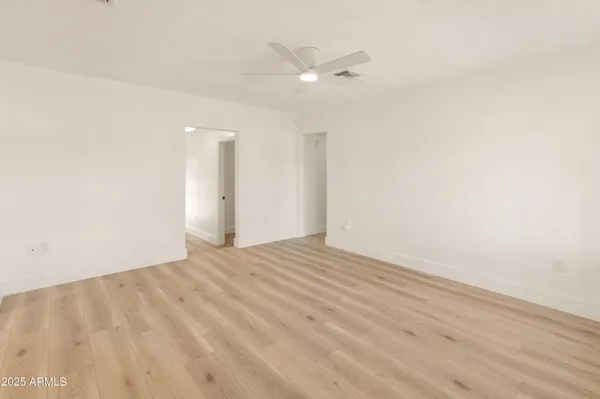 a view of an empty room with wooden floor