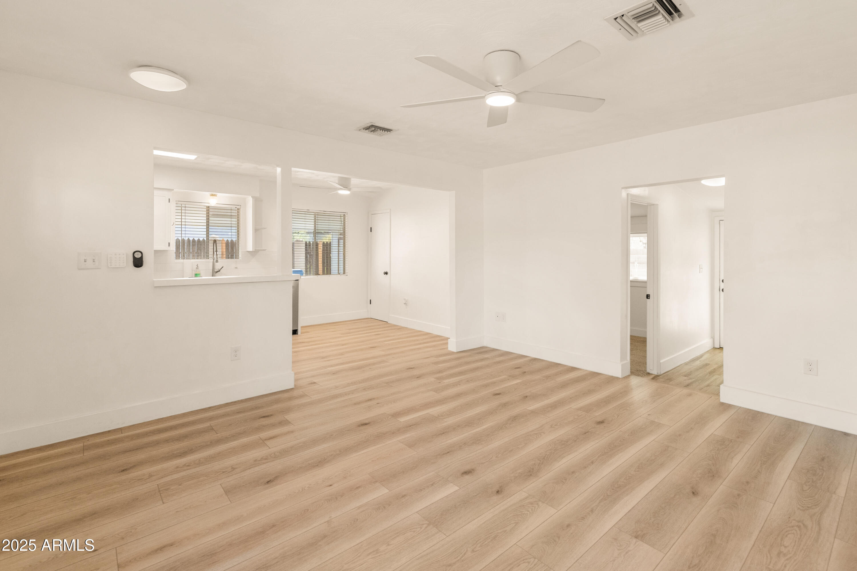 1407 East Mountain View Road Phoenix, AZ 85020 - Photo 10 of 35 an empty room with wooden floor and windows