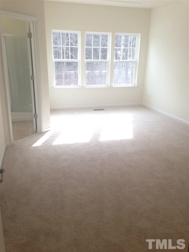 604 Edgewater Ridge Court Apex, NC 27523 - Photo 12 of 20 a view of empty room with windows