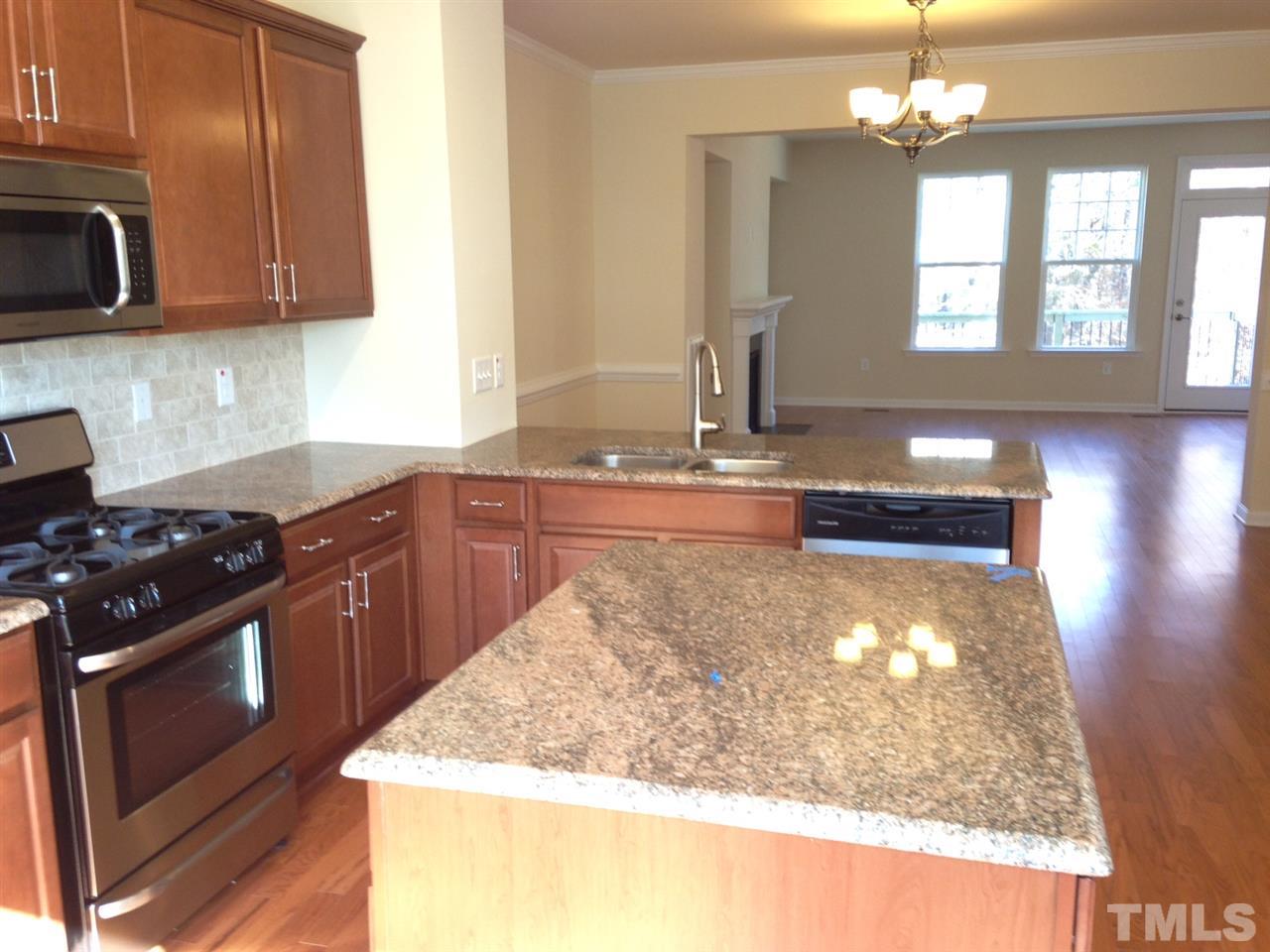 604 Edgewater Ridge Court Apex, NC 27523 - Photo 9 of 20 a kitchen with a stove and a sink