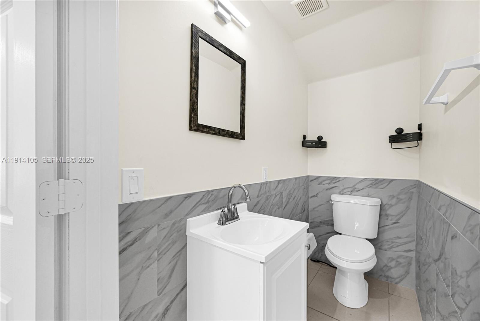 26100 Southwest 134th Place Homestead, FL 33032 - Photo 13 of 39 a bathroom with a toilet sink and mirror