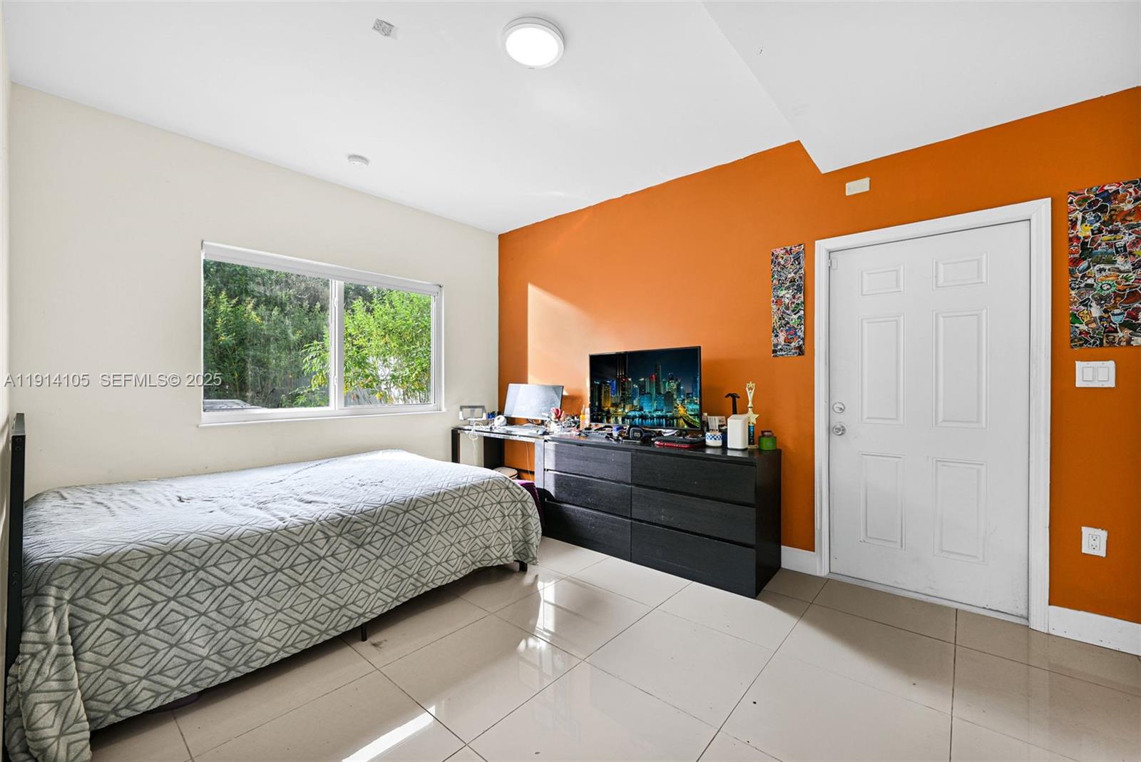 26100 Southwest 134th Place Homestead, FL 33032 - Photo 14 of 39 a bedroom with a bed and a flat screen tv