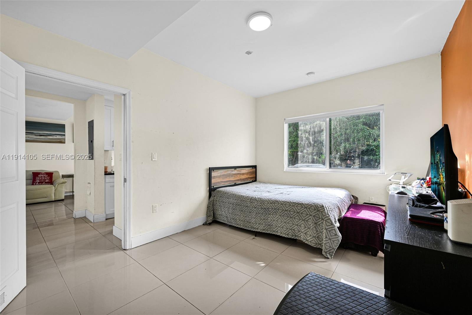 26100 Southwest 134th Place Homestead, FL 33032 - Photo 15 of 39 a bedroom with a bed and a window