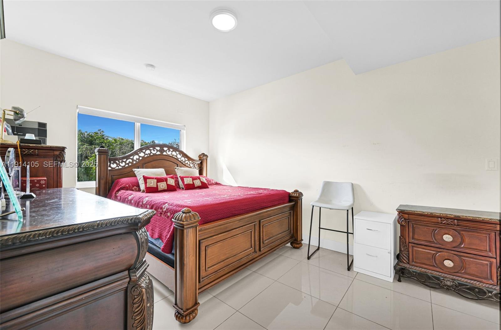 26100 Southwest 134th Place Homestead, FL 33032 - Photo 18 of 39 a bedroom with a bed and a table in it