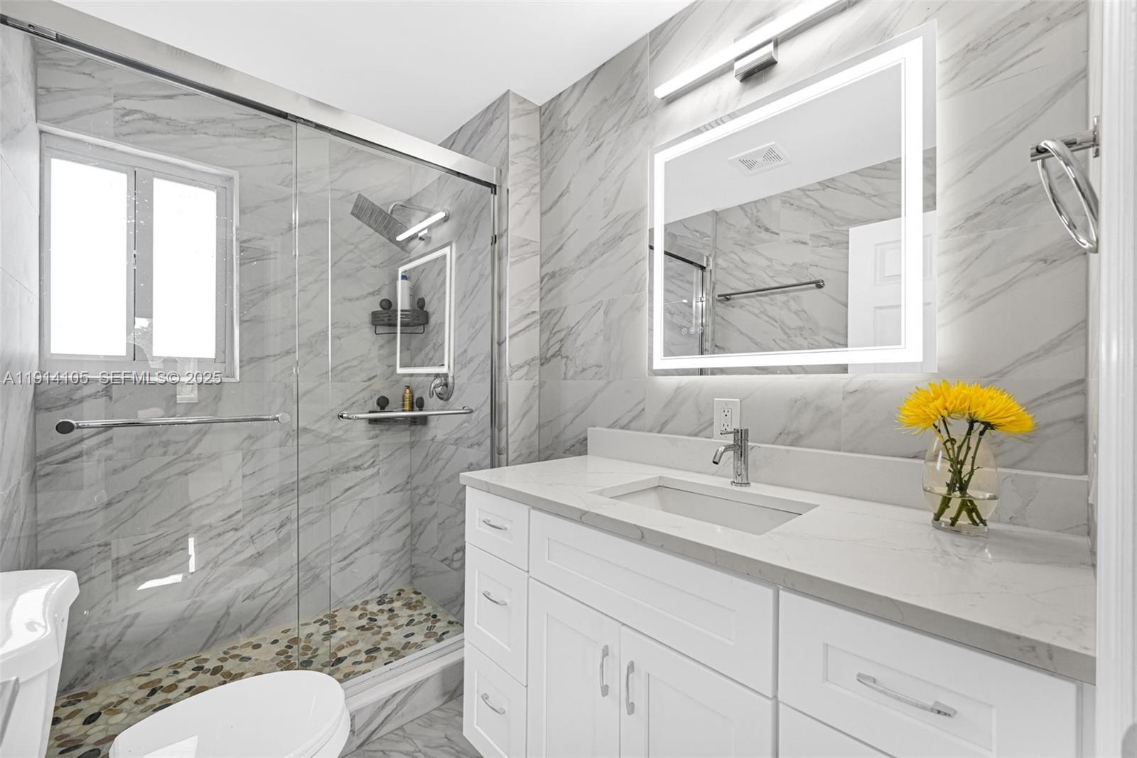 26100 Southwest 134th Place Homestead, FL 33032 - Photo 21 of 39 a bathroom with a granite countertop toilet sink and mirror