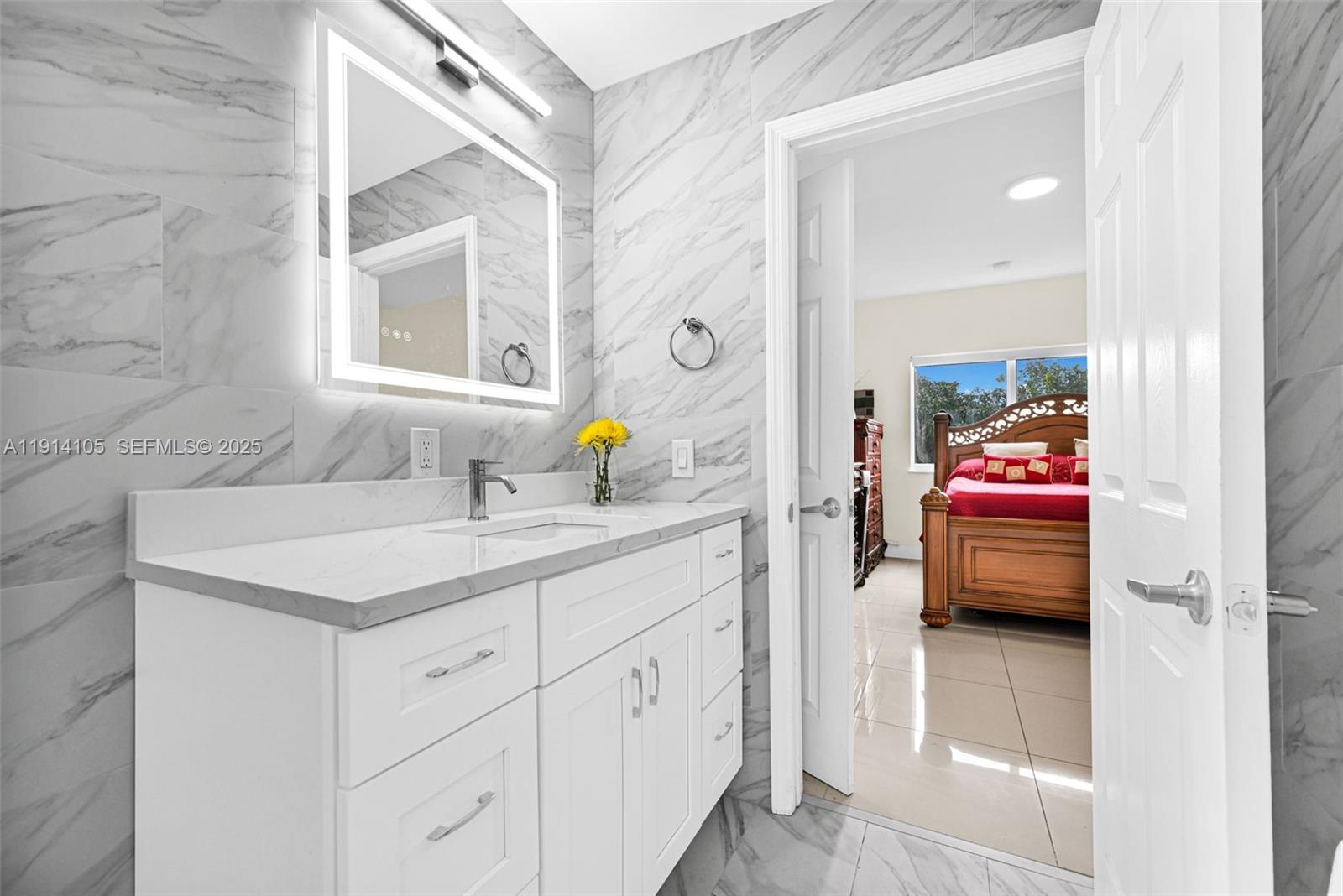 26100 Southwest 134th Place Homestead, FL 33032 - Photo 22 of 39 a en suite bathroom with a granite countertop sink and a mirror