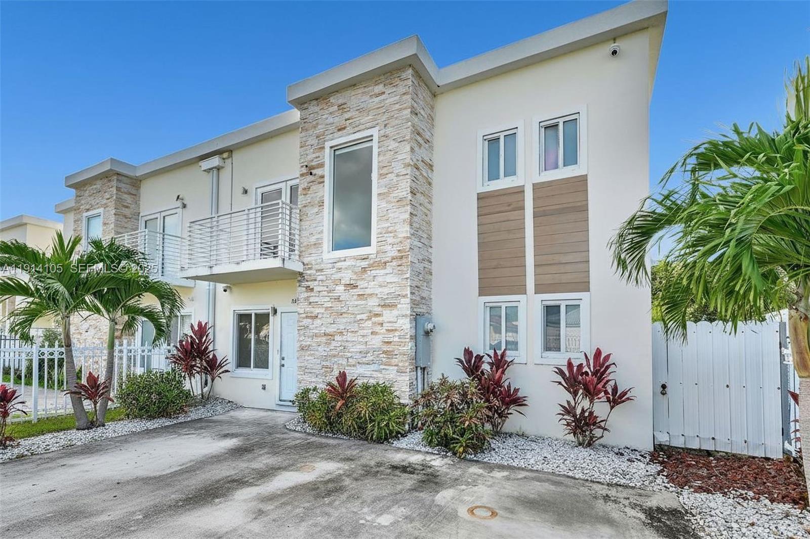 26100 Southwest 134th Place Homestead, FL 33032 - Photo 3 of 39 a front view of a house with a garage