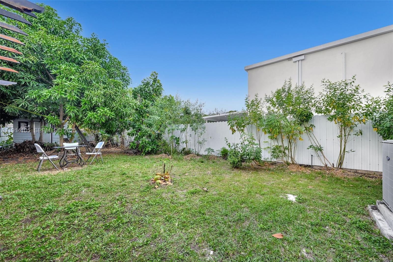 26100 Southwest 134th Place Homestead, FL 33032 - Photo 33 of 39 a backyard of a house with table and chairs