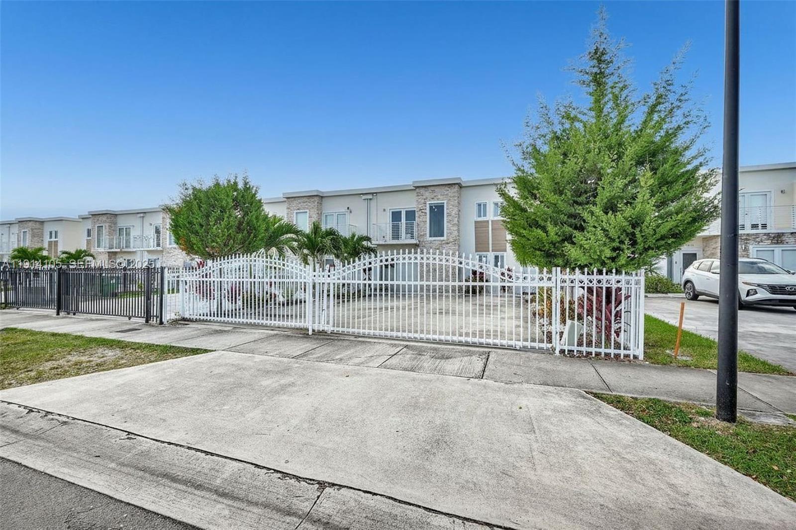 26100 Southwest 134th Place Homestead, FL 33032 - Photo 4 of 39 a view of a house with a small yard and plants