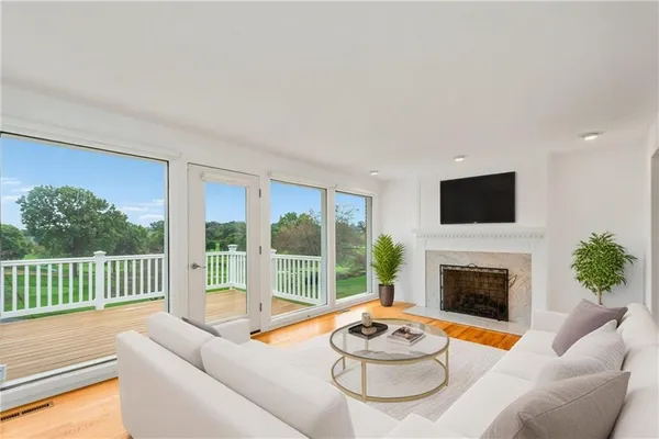 a living room with furniture a fireplace and a flat screen tv