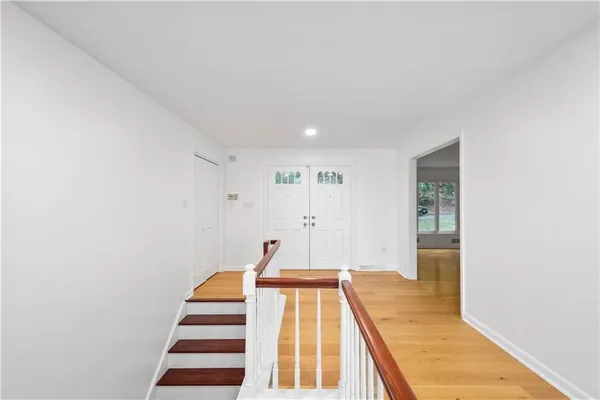 a view of a bedroom with wooden floor and staircase