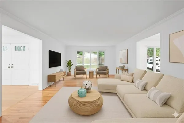 a living room with furniture and a flat screen tv
