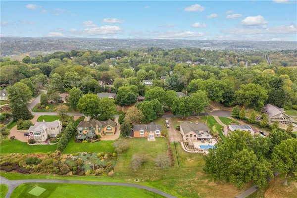 an aerial view of a golf course with parking space