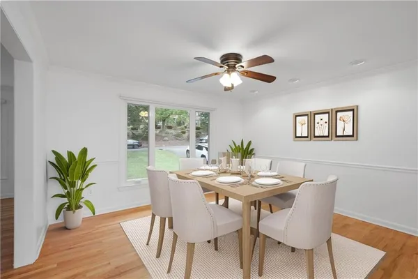 a view of a dining room with furniture window and wooden floor
