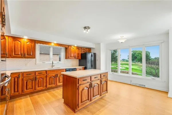 a large white kitchen with a large window
