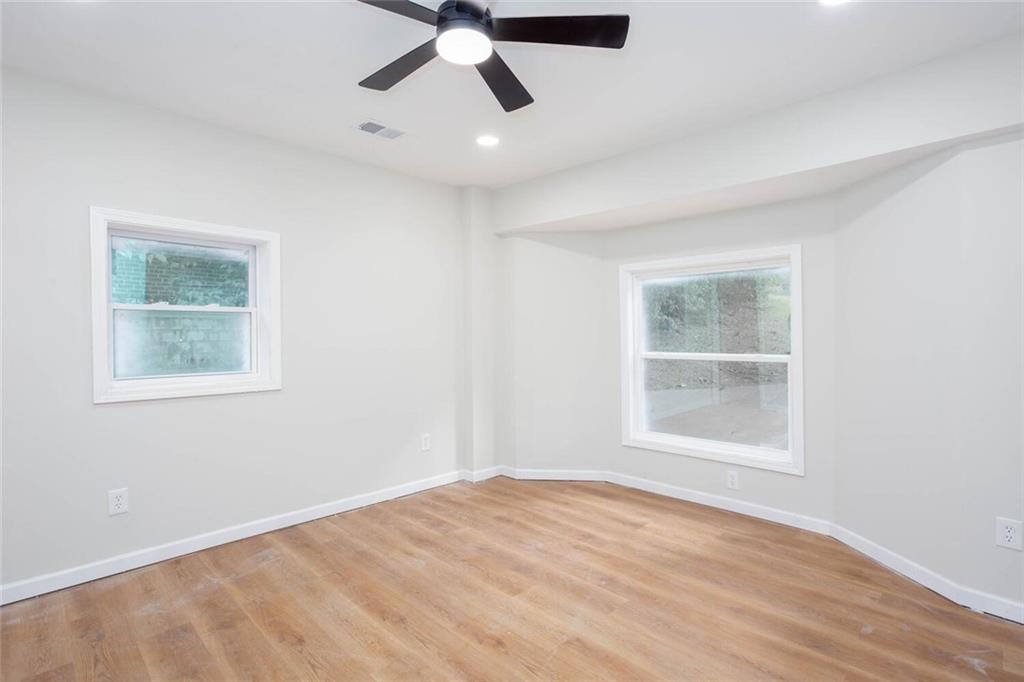 2131 Glendale Drive Decatur, GA 30032 - Photo 18 of 26 a view of an empty room with a window and wooden floor