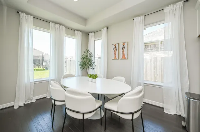 a view of a dining room with furniture and wooden floor