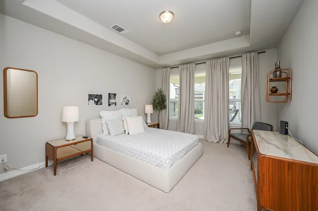 a spacious bedroom with a bed and a couch