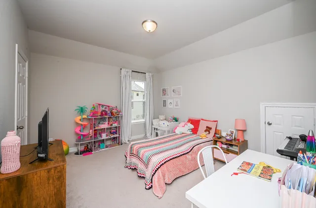 a bedroom with two beds and a bed