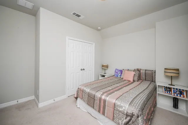 a bedroom with a bed and a closet